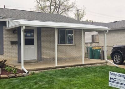 Front porch of a Michigan brick home featuring a white aluminum awning built by Wayne Craft