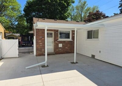 Back patio of a Michigan home featuring a white aluminum awning built by Wayne Craft