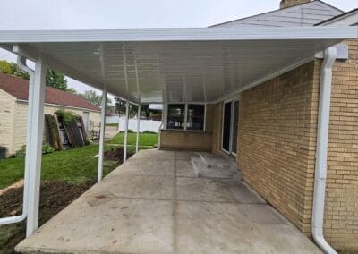 Backyard patio with white aluminum awning built by Wayne Craft